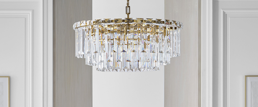 Trendy chandelier lighting fixtures from Capitol Lighting hanging above a dining room table.